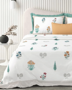 Tailor bird printed bedsheet on king-size bed