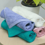 Premium face towel in white folded on counter