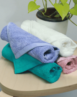Premium face towel in white folded on counter